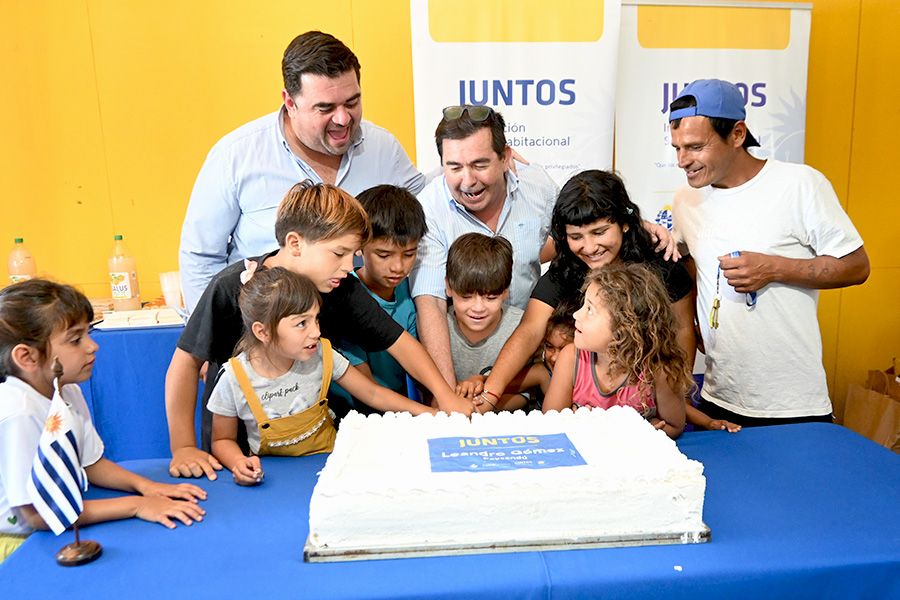 Intendente cortando torta junto a niños